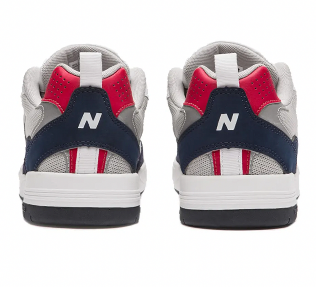 A pair of NB NUMERIC 808 Tiago sneakers with a white, blue, and red color scheme.