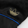 A close up of the ADIDAS logo on black ADIDAS TYSHAWN VELOUR SWEATPANTS.