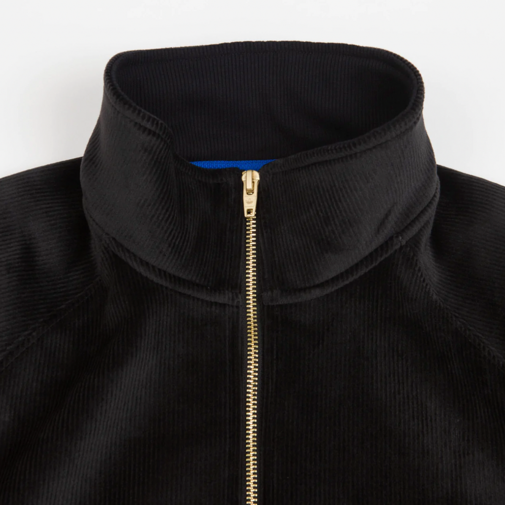 A close up of an ADIDAS TYSHAWN VELOUR JACKET with a zipper.