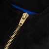 A close up of the zipper on the black ADIDAS TYSHAWN VELOUR JACKET.