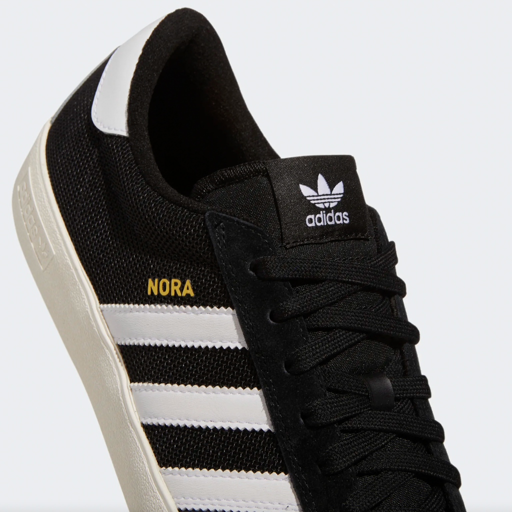 A pair of black and white ADIDAS NORA CORE BLACK / CLOUD WHITE sneakers with a white sole.