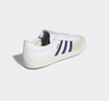 A pair of white ADIDAS NORA GREY ONE/ SHADOW NAVY / GOLD sneakers on a white background.