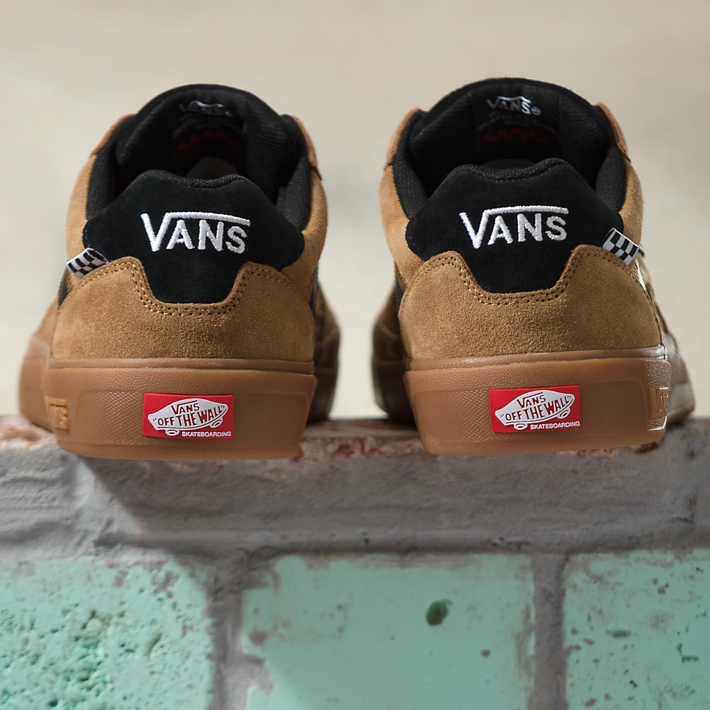 A pair of Vans SKATE WAYVEE Tobacco Brown shoes sitting on top of a brick wall.