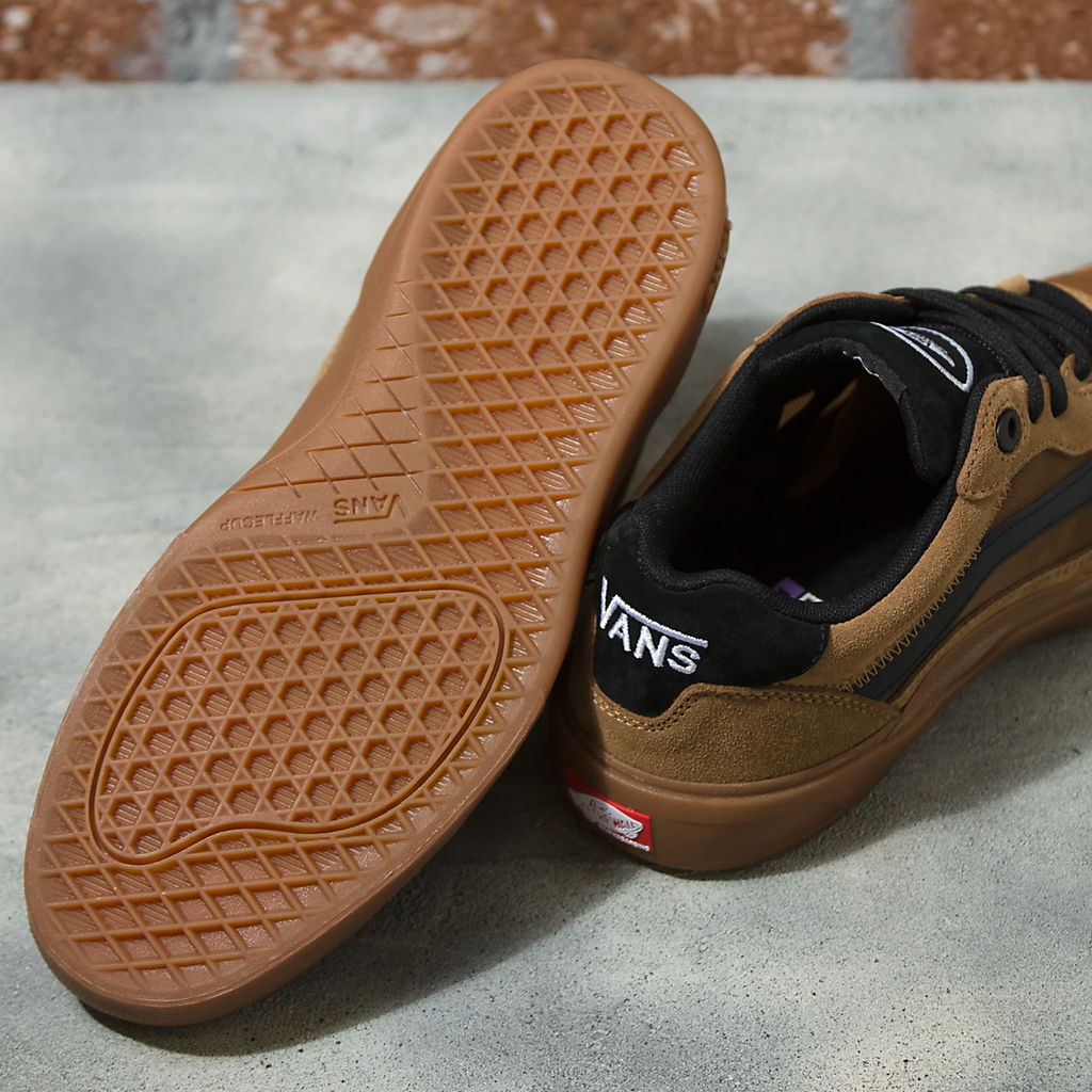 A pair of VANS SKATE WAYVEE TOBACCO BROWN shoes sitting on top of a cement floor.