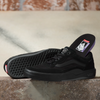 A pair of VANS SKATE WAYVEE BLACK / BLACK shoes sitting on a ledge.