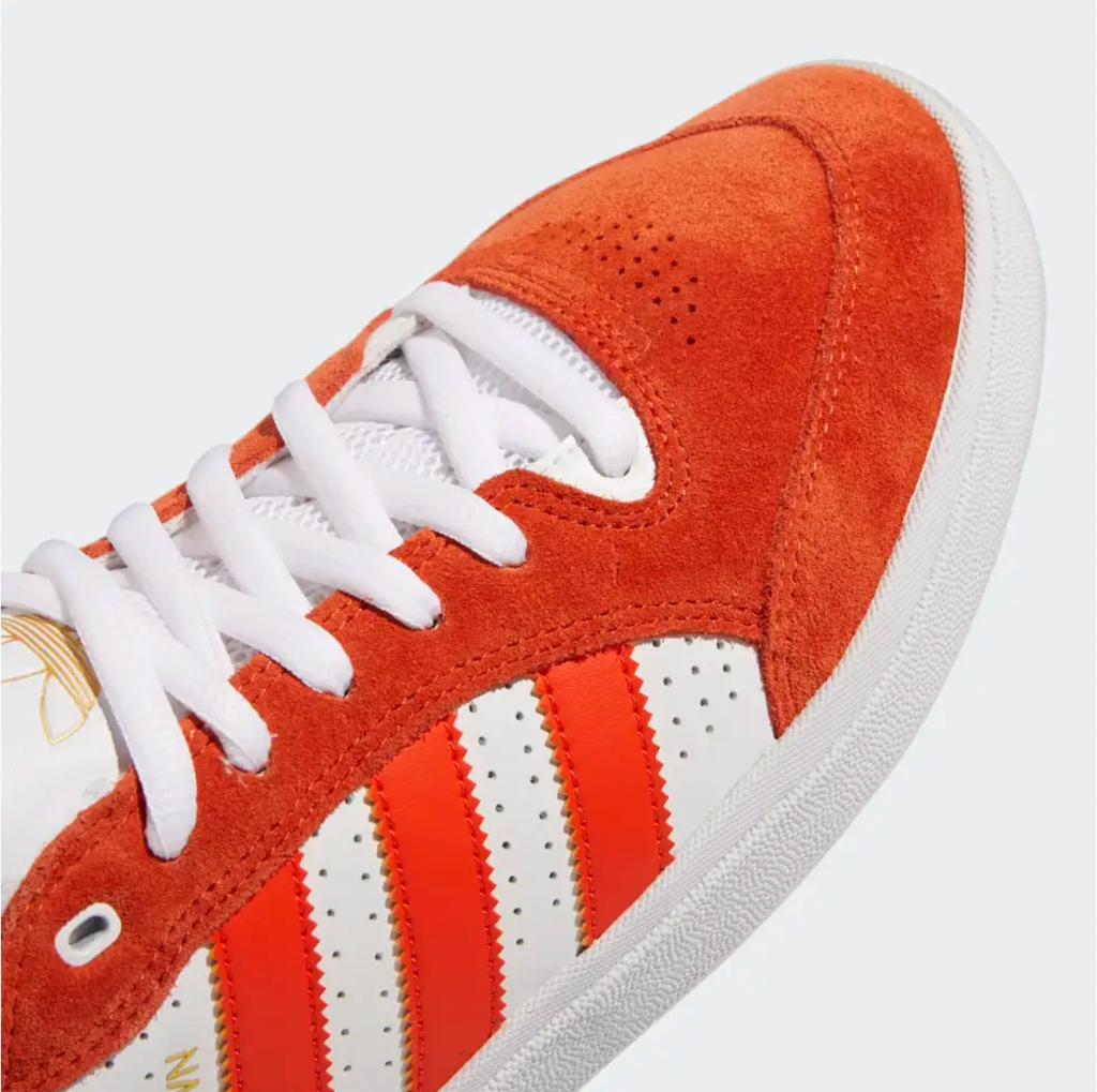 An ADIDAS Tyshawn Low Collegiate Orange/Collegiate Orang/White sneakers on a white background.