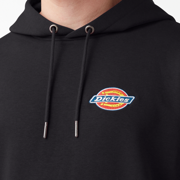 A man wearing a DICKIES fleece embroidered logo hoodie in black.