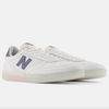 An NB Numeric 440 white and blue sneaker with a neon sole.