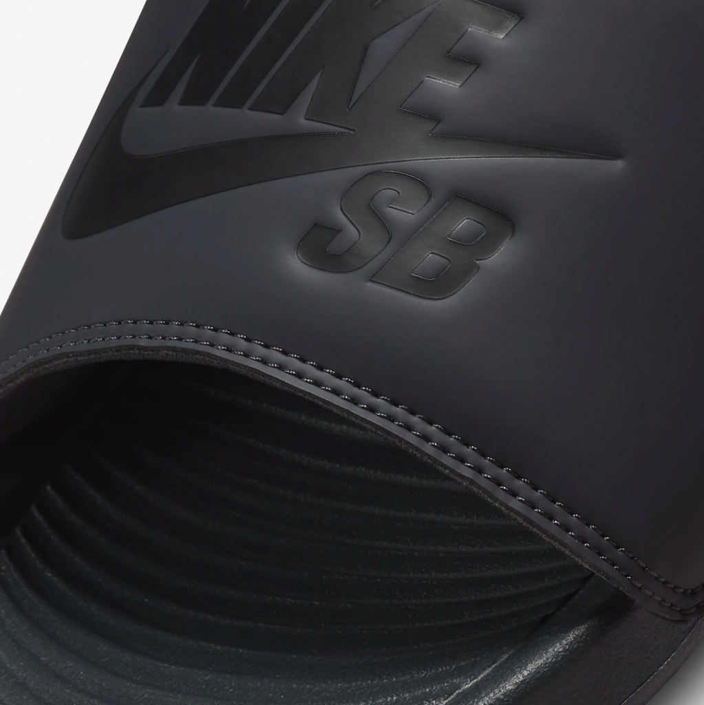 A close up of a black Nike SB Victor One Slide SB Anthracite / Black sandals.