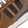 A close up of ADIDAS FORUM 84 LOW ADV x HEITOR WILD BROWN / CARDBOARD / DARK BROWN shoe with white laces.