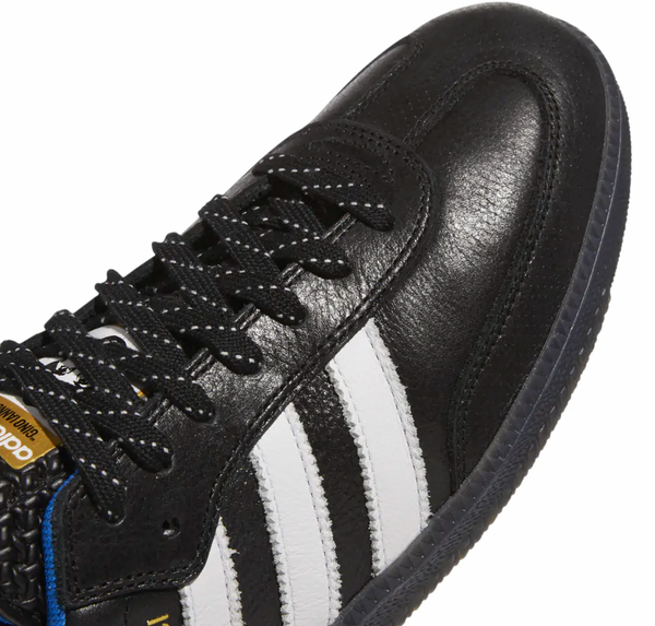 A pair of black and white ADIDAS GINO SAMBA ADV RYR BLACK / WHITE sneakers with white stripes.