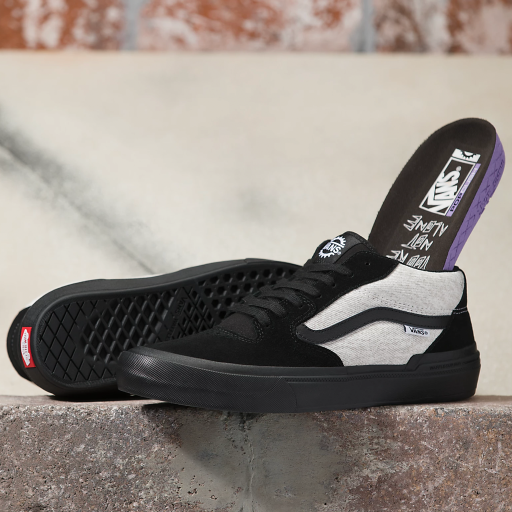 A pair of VANS BMX Style 114 Fast and Loose Black shoes sitting on a ledge.