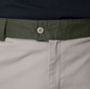 A close up of a person wearing a green DICKIES belt.