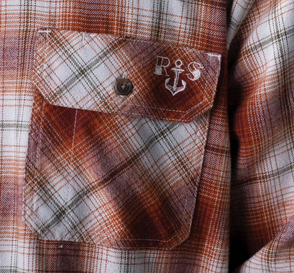 A close up of a DICKIES RONNIE SANDOVAL BRUSHED FLANNEL SHIRT BURNT OMBRE with an anchor on it.
