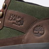 A pair of green and brown VANS SKATE X TIMBERLAND HALF CAB HIKER boots with a logo on the side.