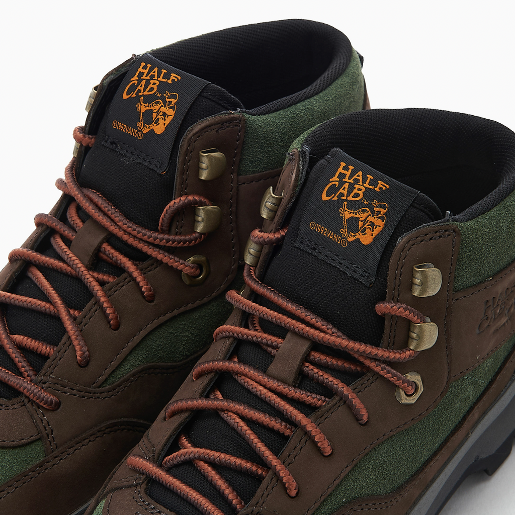 A pair of VANS SKATE X TIMBERLAND HALF CAB HIKER GREEN / BROWN hiking boots by Vans.