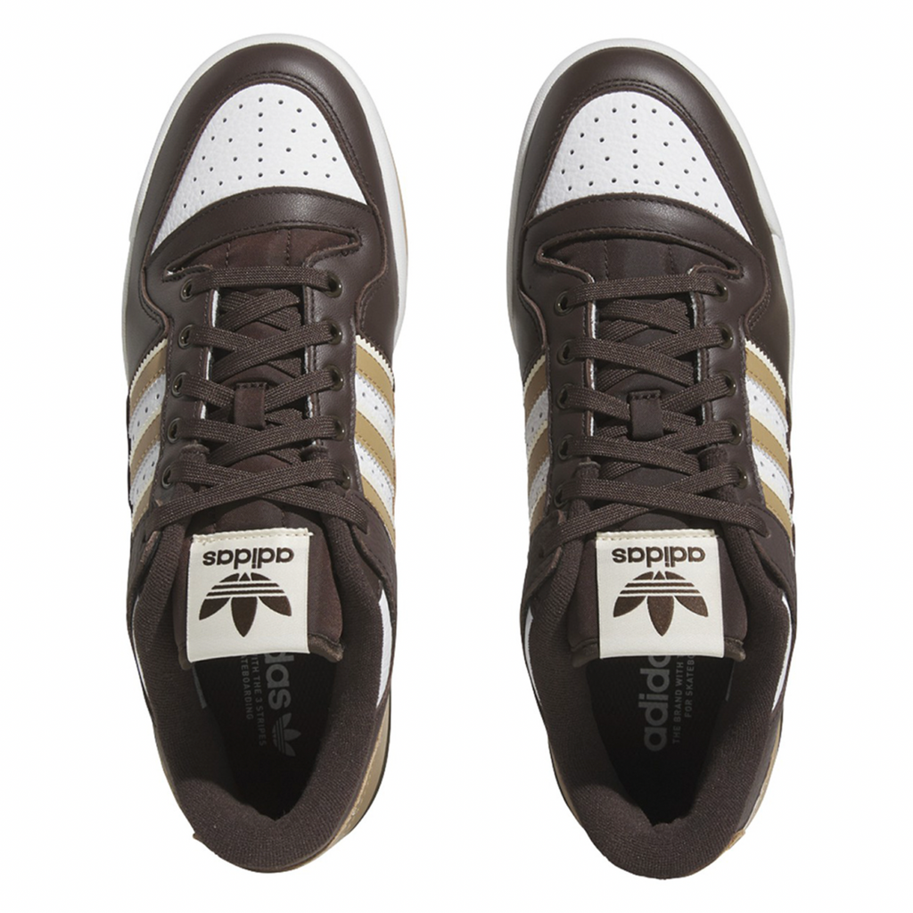 A pair of ADIDAS FORUM 84 LOW ADV DARK BROWN / ECRU TINT / WHITE sneakers on a white background.