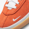 The Nike SB BRSB Deep Orange / Pine Green / White is orange and white.