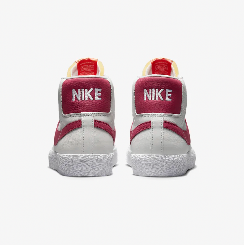 A pair of white and red Nike SB Blazer Mid ISO sneakers.