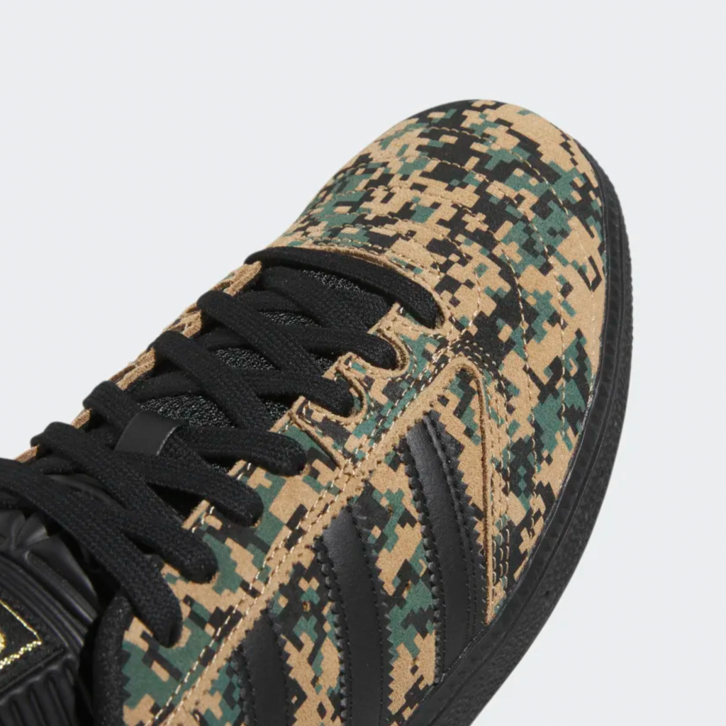 A ADIDAS BUSENITZ BLACK / CARDBOARD / GOLD sneakers with black laces.