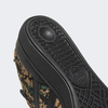 A close up of an ADIDAS BUSENITZ BLACK / CARDBOARD / GOLD sneaker.