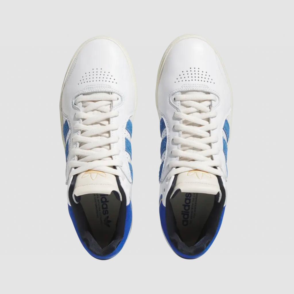 A pair of white and blue ADIDAS TYSHAWN sneakers.