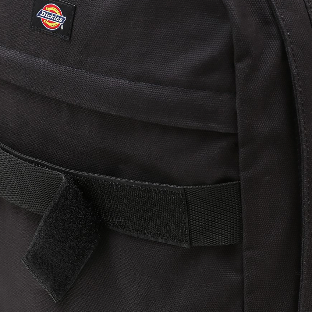 A close up of a DICKIES DUCK CANVAS BACKPACK BLACK with a black strap.