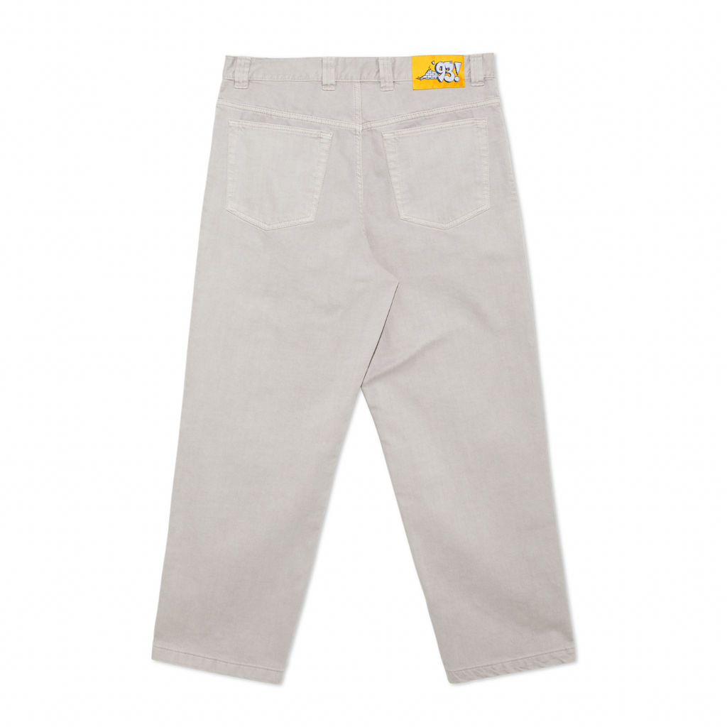 A pair of POLAR '93! DENIM PALE TAUPE pants with a yellow tag on the side.