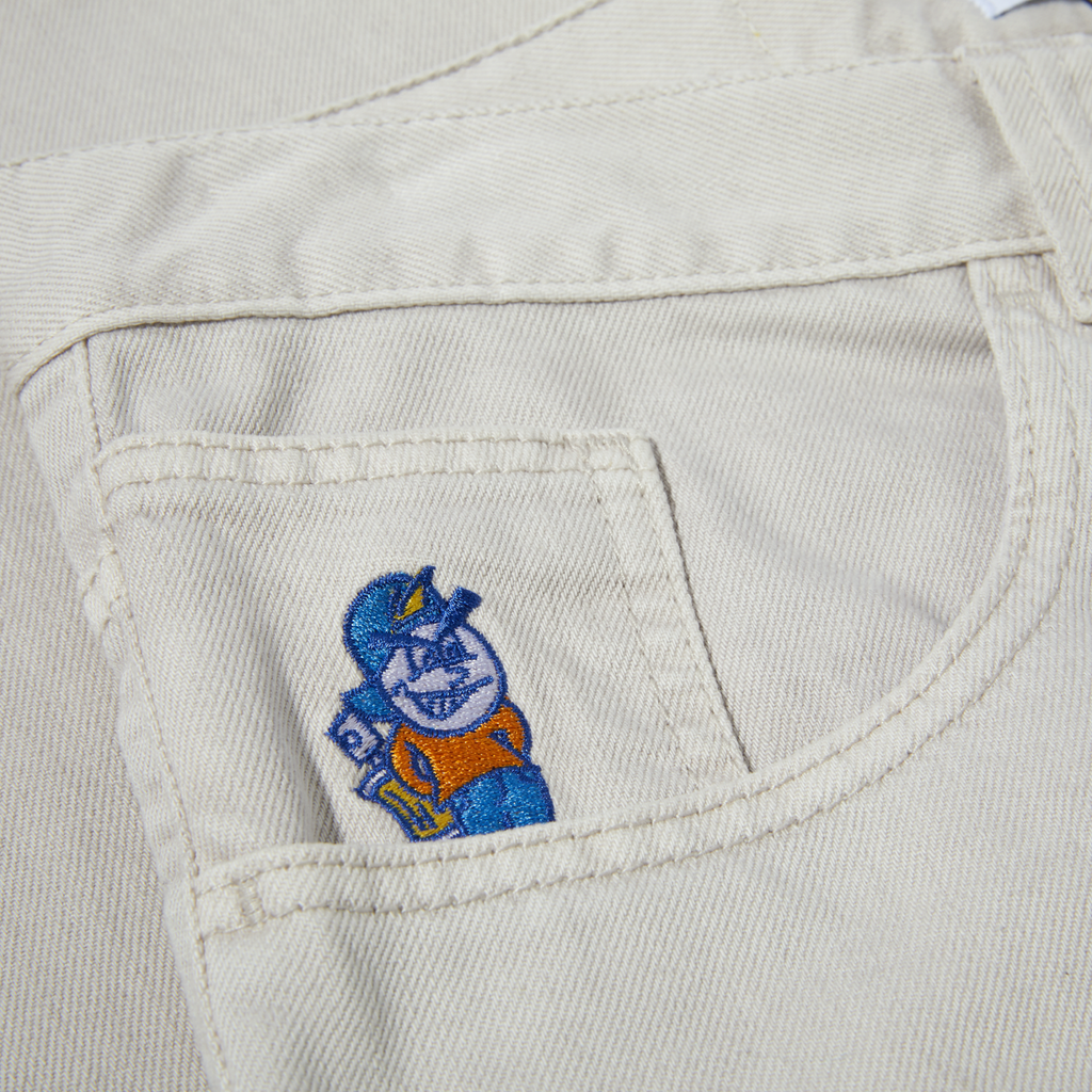 A close up of a pocket on a white shirt featuring the POLAR '93! DENIM PALE TAUPE by POLAR.