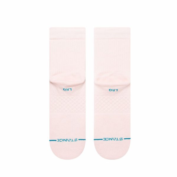 A pair of STANCE socks in light pink with "ICON QUARTER" in blue on the toes, size marked as "MEDIUM".
