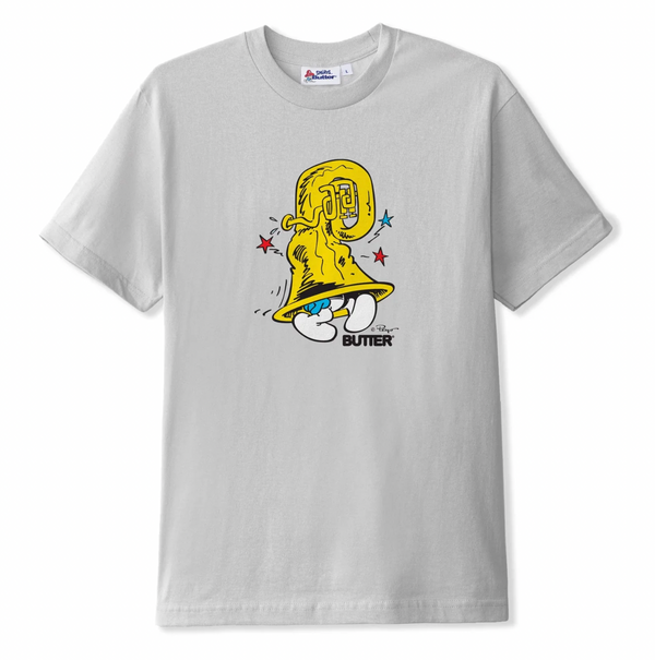 A Butter Goods X The Smurfs Harmony Tee Cement with a cartoon character on it.
