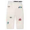 A pair of Butter Goods X The Smurfs Forage Wide Leg Pant Natural with patches on them.
