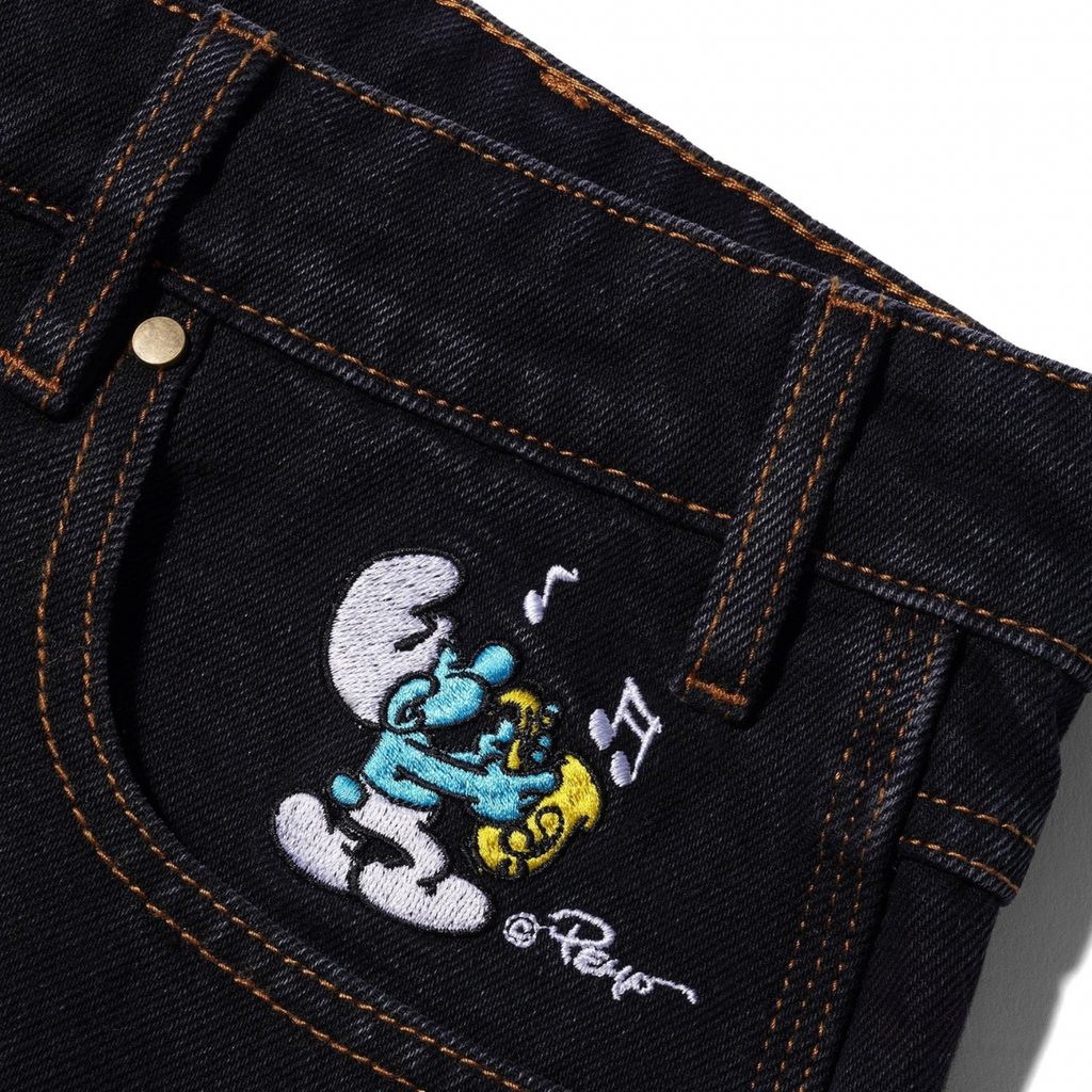 A pair of Butter Goods X The Smurfs Harmony Denim Pants with a cartoon character on it.