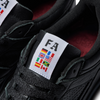 A pair of black ADIDAS sneakers with flags on them, featuring the ADIDAS X FA Experiment 2 Triple Black design.