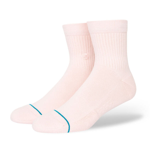 A pair of STANCE SOCKS ICON QUARTER in light pink with a ribbed cuff and thin blue stripe near the toes, positioned upright against a white background.