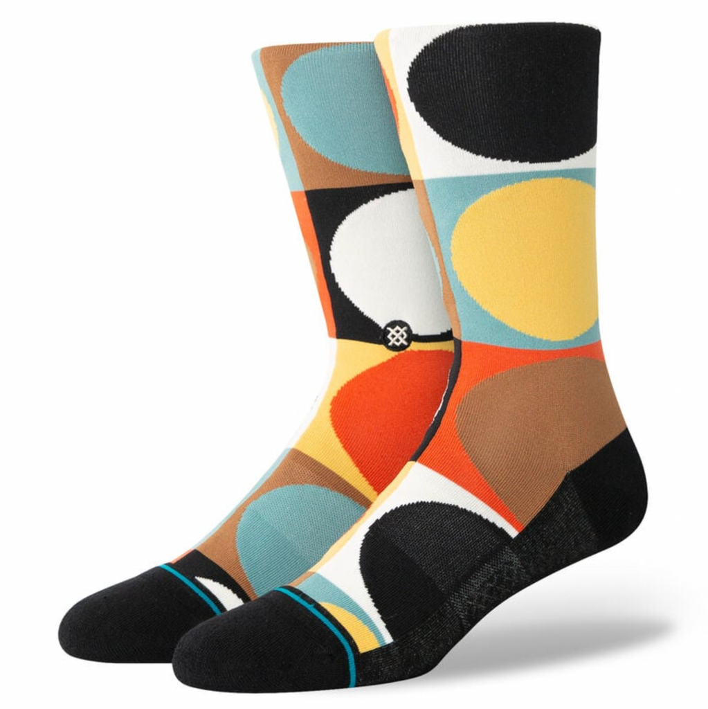 A pair of STANCE socks with circles on them.