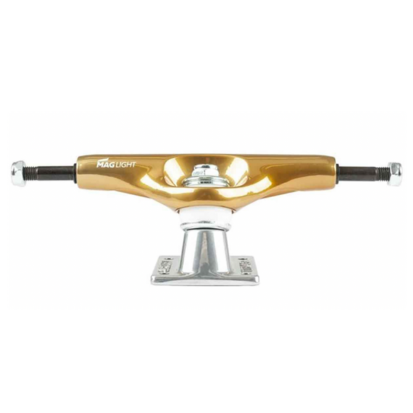 Product image featuring a Tensor MAG-LIGHT 5.25 skateboard truck with a glossy gold/silver hanger and black axle, mounted on a sleek silver baseplate. The brand name "Tensor" stands out prominently on the hanger.