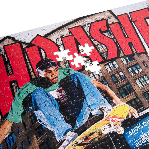 A partially completed 1000-piece THRASHER Tyshawn Jones Puzzle features a skateboarder with red "THRASHER" text in the background. Several pieces near the center are missing, creating gaps in the striking scene likely inspired by Tyshawn Jones.