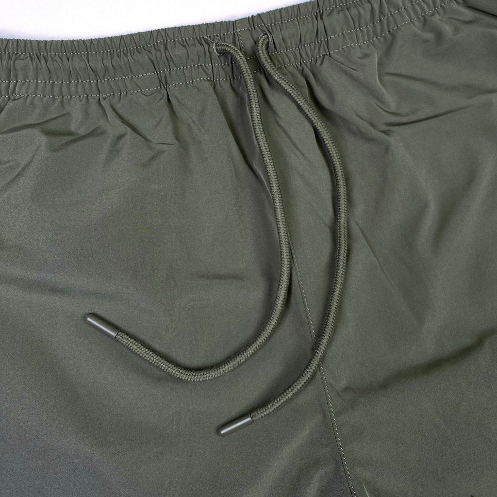 A pair of BLUETILE SURPLUS WORK OUT SHORT CYPRESS with a drawstring from Bluetile Skateboards.