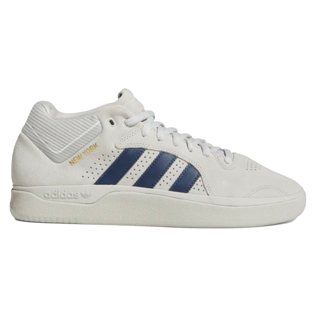 A white and blue Adidas Tyshawn Grey One / Collegiate Navy / Cloud White shoe.