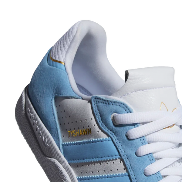The ADIDAS TYSHAWN LOW APP SKY RUSH is blue and white with gold metallic accents.