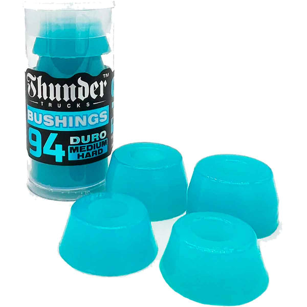 A set of four blue THUNDER PREMIUM BUSHING 94D BLUE bushings in a plastic container designed for MEDIUM_HARD performance by DELUXE.