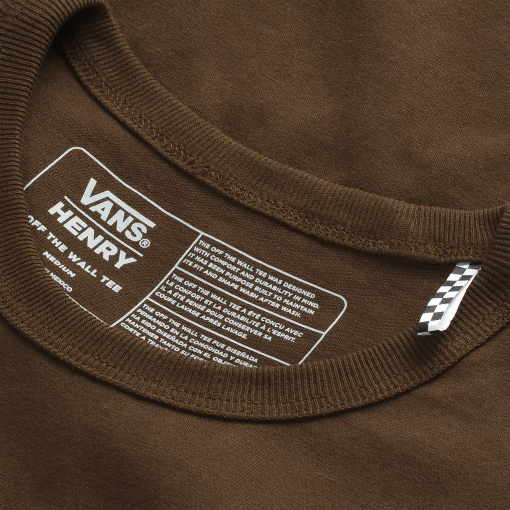 A VANS Justin Henry Pocket Tee Demitasse with a white label on the pocket.