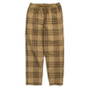 A pair of VANS RANGE PLAID BAGGY TAPERED ELASTIC WAIST PANTS in brown plaid on a white background.