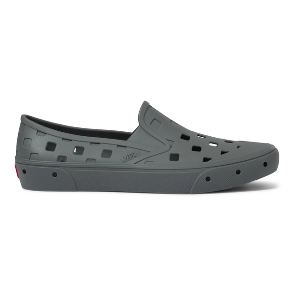 A pair of VANS TREK SLIP ON PEWTER shoes with holes on them.