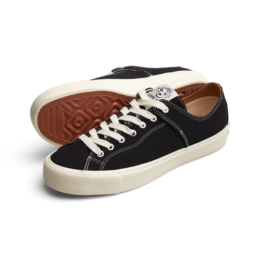 A pair of LAST RESORT AB black sneakers with white soles, perfect as a last resort for dancers.