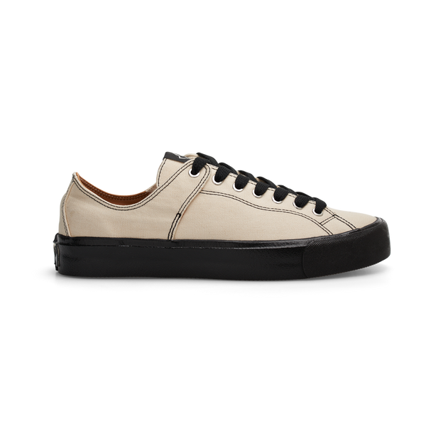 A white leather LAST RESORT AB X DANCER VM003 CANVAS WHITE sneaker with black soles.