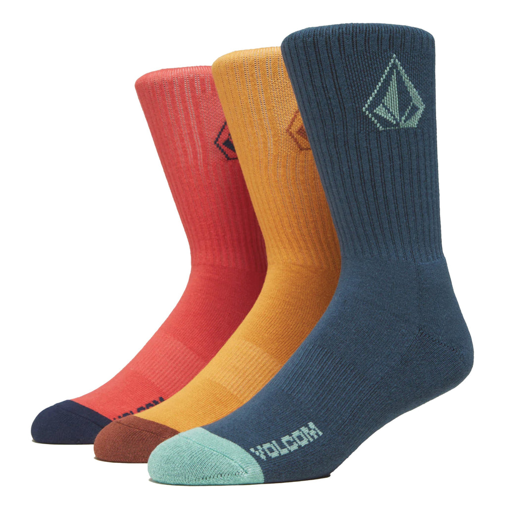 Three pairs of colorful VOLCOM FULL STONE SOCK 3-PACK MARINA BLUE crew socks arranged side by side against a white background, each featuring the Jacquard stone logo.