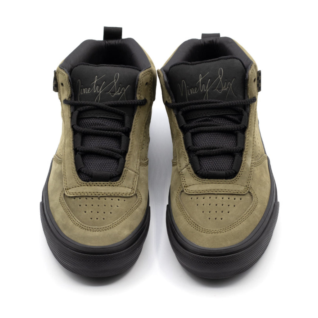 A pair of VANS SKATE MC 96 VCU DARK OLIVE shoes that are on a white surface.