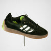 A black and green ADIDAS PUIG CORE BLACK / WHITE / GUM shoe on a white background.